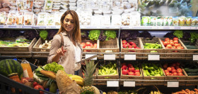 Woman with tablet checking shopping cart to see if she has everything she needs for lunch scaled